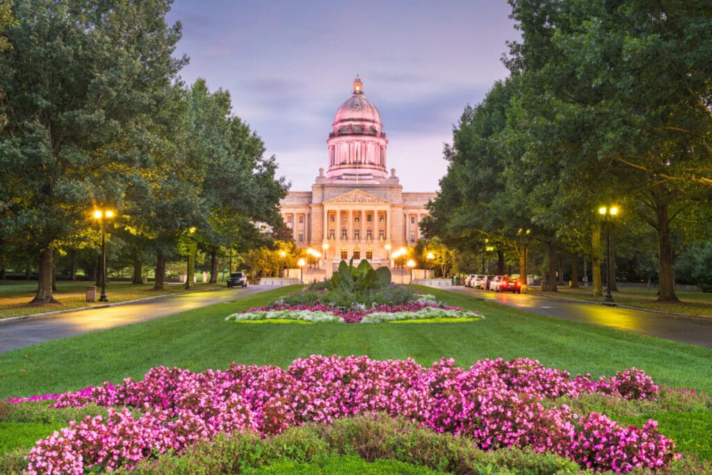 A large building with flowers in the foreground.