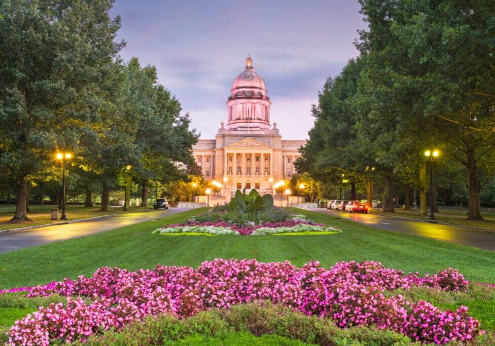 A large building with flowers in the foreground.